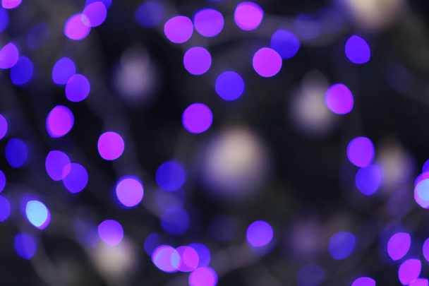 Blurred view of glowing Christmas lights as background. Festive mood - Zdjęcie, obraz