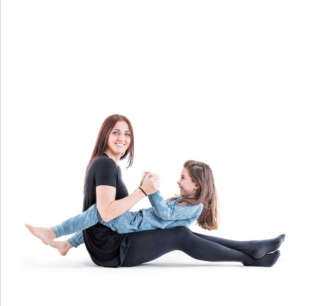 Loving mother and her daughter child girl playing and hugging on white background. Concept of happy. Studio shoot - Фото, зображення