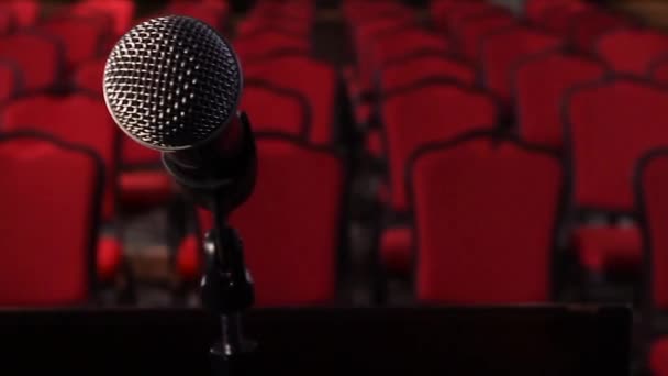On an empty stage microphone in front of an empty hall. Scene. Microphone on stage close-up - Footage, Video