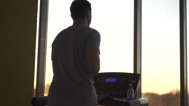 Young man 30 old engaged in sports on the treadmill. - Кадри, відео
