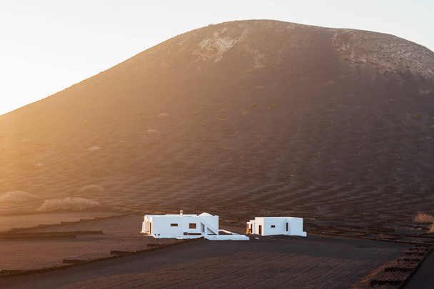 Beautiful sunset Lanzarote landscape with mountains and traditiona white house. Travel concept - Zdjęcie, obraz