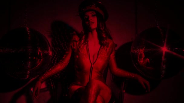 σέξι δροσερό Λατίνα γυναίκα που ποζάρει στο εκπληκτικό κόκκινο παιχνίδι catsuit με εμβολιασμένο στρατιωτική καπέλο και vintage ghetto blaster - Πλάνα, βίντεο