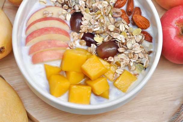 yogurt with apple, mango and grape topping - 写真・画像