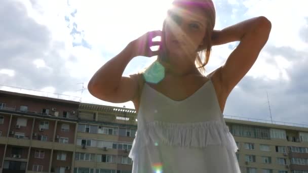 Woman in summer dress against the sun posing to the camera - 映像、動画