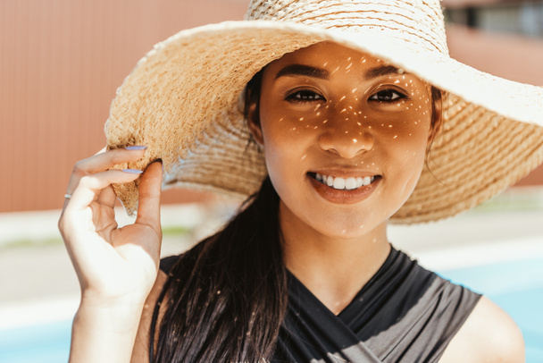 happy asian girl in swimsuit and straw hat - Zdjęcie, obraz