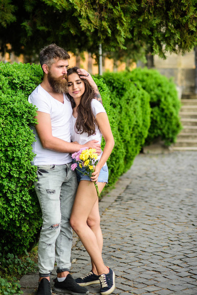 Man bearded hipster hugs gorgeous girlfriend. Park best place for romantic walk. Couple in love romantic date walk nature park background. Great date tips. Love relations romantic feelings - Foto, immagini