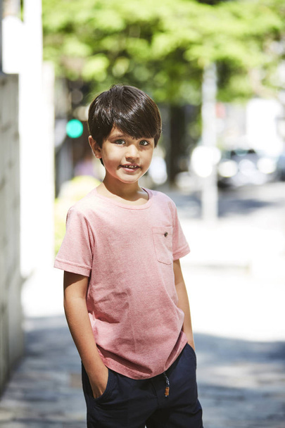 Cool kid in t-shirt looking at camera, portrait - 写真・画像
