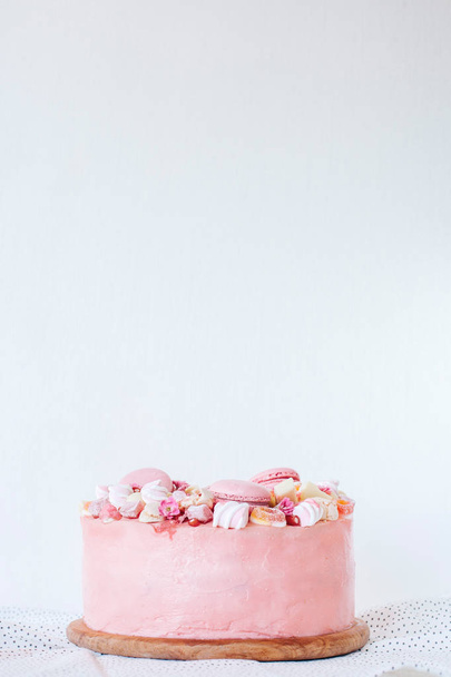 Pink cake. Decoration from sweets, macarons, marshmallows, white chocolate. Sweet birthday present. For girl. - Zdjęcie, obraz
