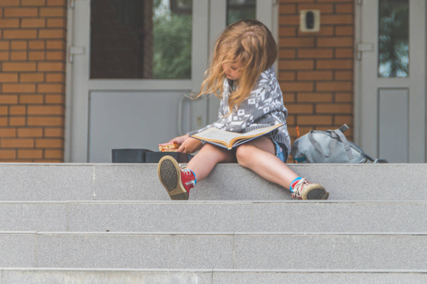 on a Sunny day at school, kindergarten rest girl, a child on the street at recess - 写真・画像