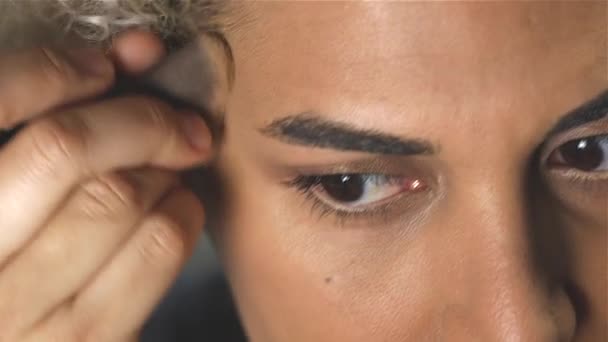 Slow motion of Transgender woman putting make-up on and smiling - Imágenes, Vídeo