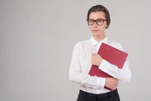 Young serious business girl holds folder isolated - Fotografie, Obrázek
