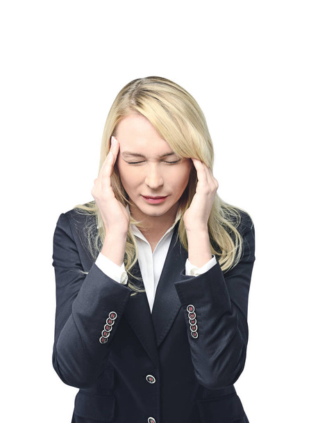 Young caucasian businesswoman with long blond hair wearing a suit having a severe headache. Concept of stress and overwork in business. Isolated portrait - Photo, Image