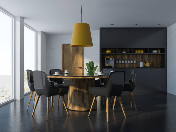 白い壁、黒い床、黒、木製の椅子が付いた丸テーブル、コーヒー マシンと食器棚と居心地の良いモダンなダイニング ルームのインテリア。3 d レンダリング - 写真・画像