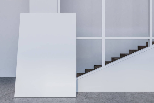 Empty room interior with gray walls, a concrete floor with a vertical mock up poster standing on it and a staircase. Concept of marketing and product placement. 3d rendering - Φωτογραφία, εικόνα