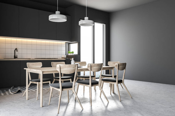 Side view of a French window kitchen with black walls, a concrete floor, a table with chairs and black countertops. 3d rendering - Фото, зображення