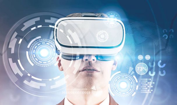 Young businessman in VR glasses. HUD interface and infographics foreground. Hi tech innovation communication global world concept. Toned image double exposure Elements of this image furnished by NASA - Photo, image