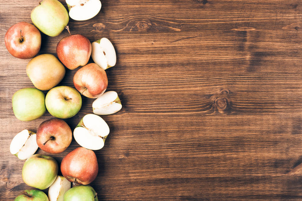 Sweet juicy red and green apples on wooden background. Free copy space for text. Top view, flat lay - Photo, Image