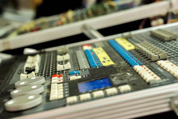 Gros plan et recadrage de boutons avec bouton du panneau de commande du mélangeur de musique sonore sur fond flou
. - Photo, image