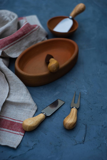 Traditional georgian pottery ketse pan and cheese knifes on concrete background with copy space - Photo, Image