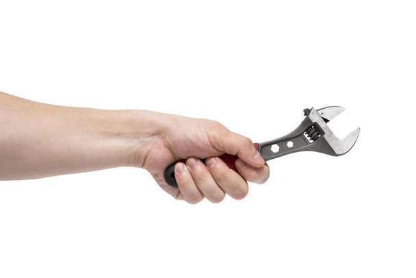 Man's hand holding  wrench isolated over white. The hand holds a wrench on white - Photo, Image