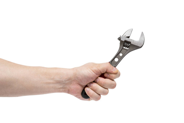 Man's hand holding  wrench isolated over white. The hand holds a wrench on white - Photo, Image