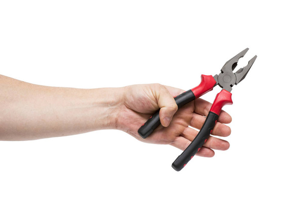 Pliers in a hand on a white background. Hand is holding universal pliers on white background - Photo, image