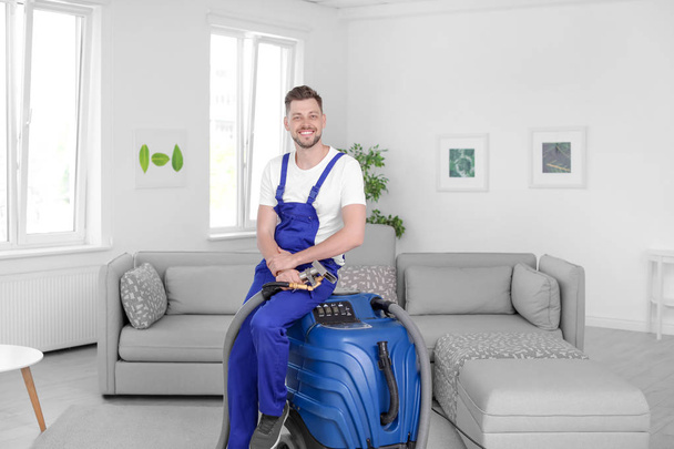 Dry cleaning worker with professional apparatus indoors - Foto, Bild