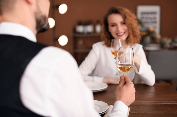 Young couple with glasses of delicious wine in restaurant - Photo, Image