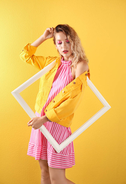 Beautiful young woman posing on color background. Summer fashion - 写真・画像