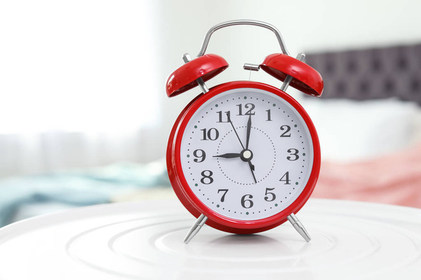 Alarm clock on table in bedroom. Time to wake up - Valokuva, kuva