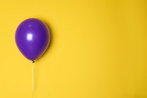 Purple balloon on color background. Celebration time - Φωτογραφία, εικόνα
