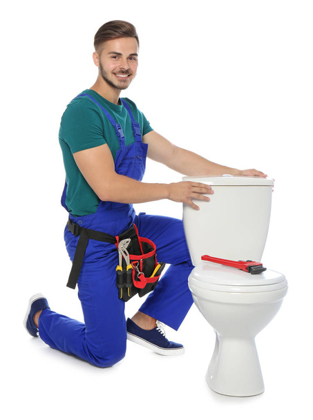 Young man working with toilet tank, isolated on white - Foto, Imagem