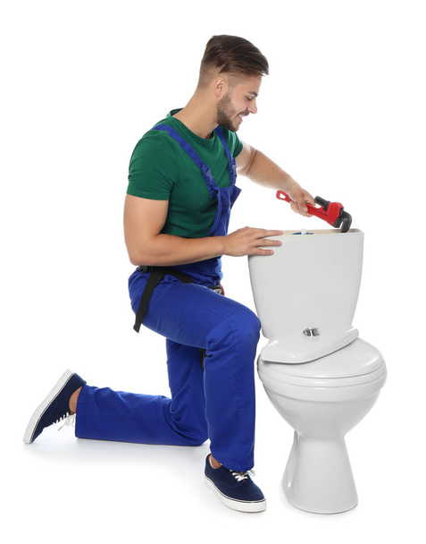 Young man working with toilet tank, isolated on white - Fotografie, Obrázek