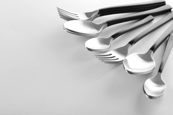Forks and spoons on white background. New cutlery - Фото, изображение