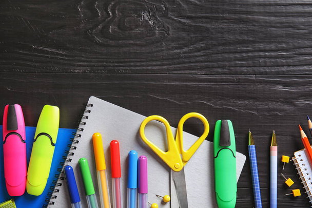 Different school stationery with space for design on wooden background, flat lay - 写真・画像