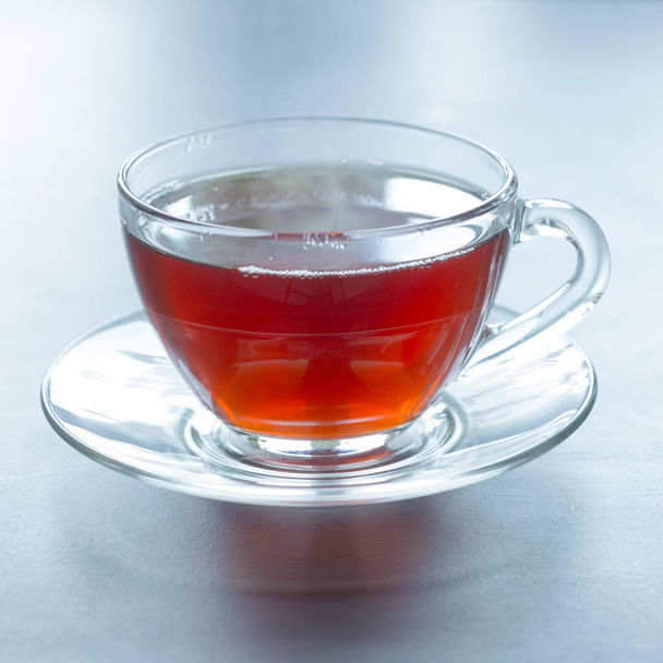 A glass mug with hot black tea in the morning.  - Zdjęcie, obraz