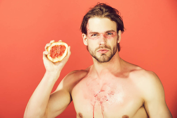 man with creative fashionable makeup hold grapefruit, vitamin - Fotografie, Obrázek
