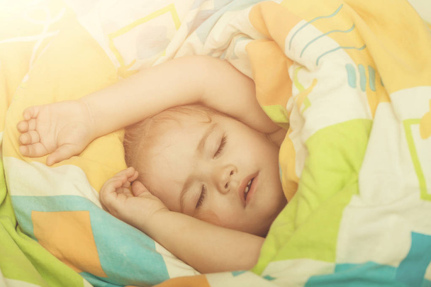 Child sleep in bed. - Фото, изображение