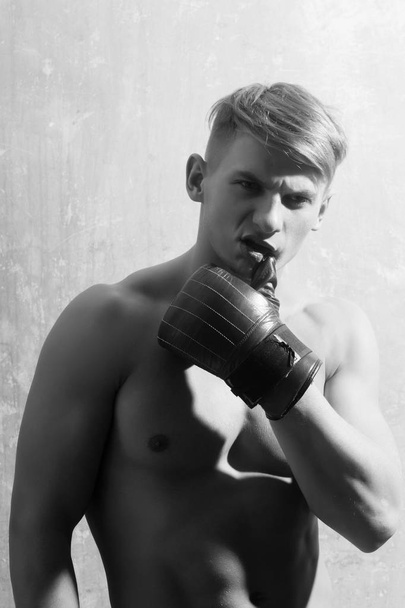 boxer with naked torso posing in red gloves - Foto, imagen
