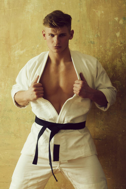 karate man posing with muscular chest in white kimono - Valokuva, kuva