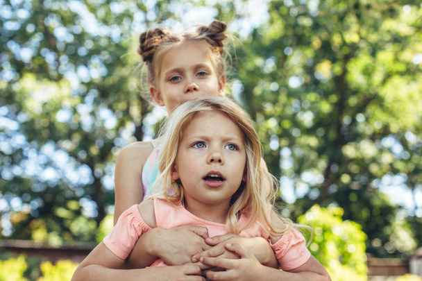 Small girls playing outdoors with delight - Fotoğraf, Görsel