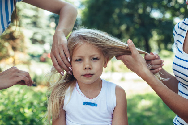 Small girl having hairdo outdoors  - Fotoğraf, Görsel