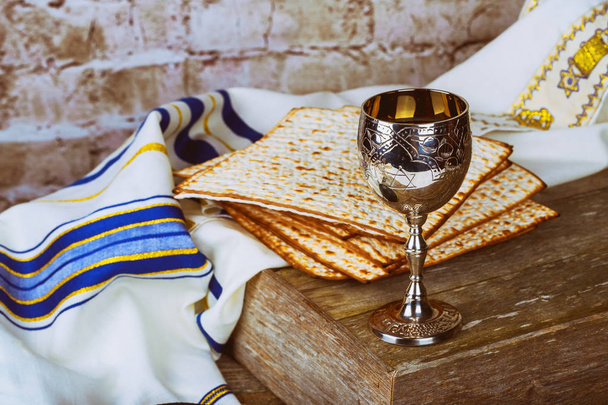 Passover background red wine and matzoh jewish holiday pesah bread over wooden board . - Photo, Image