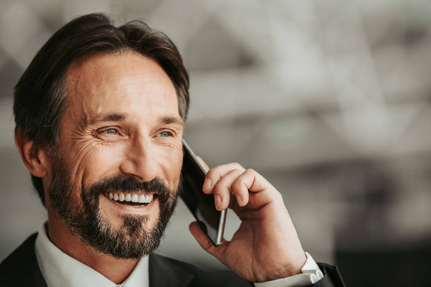 Cheerful businessman speaking on cellphone - Photo, image