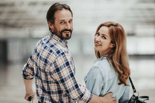 Optimistic male embracing glad wife inside - Valokuva, kuva