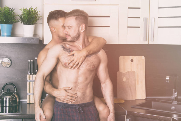 The best start of the day. Two sexy guys in the kitchen - Zdjęcie, obraz