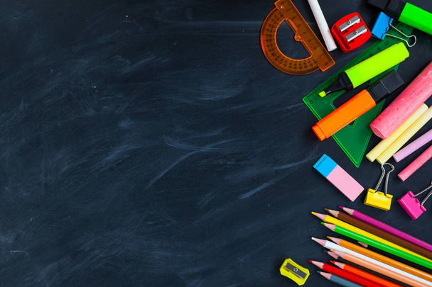Back To School concept. School supplies on blackboard background, accessories for the schoolroom - pencils, scissors, chalk, markers. Copy space top view - Φωτογραφία, εικόνα