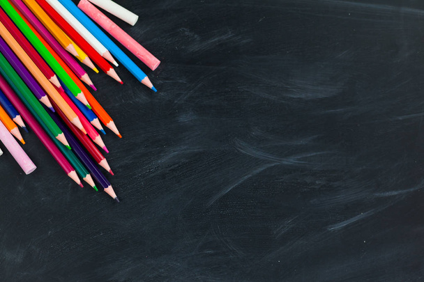 Back to School concept. Colorful pencils on blackboard background. Close up, flat lay, copy space, top view,  - Foto, afbeelding