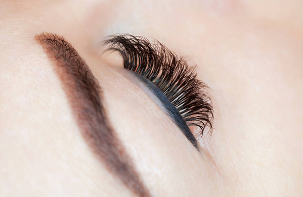 Eyelash removal procedure close up. Beautiful Woman with long lashes in a beauty salon. - Photo, Image