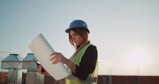 Young female at construction site analyzing the map of construction. - Filmmaterial, Video